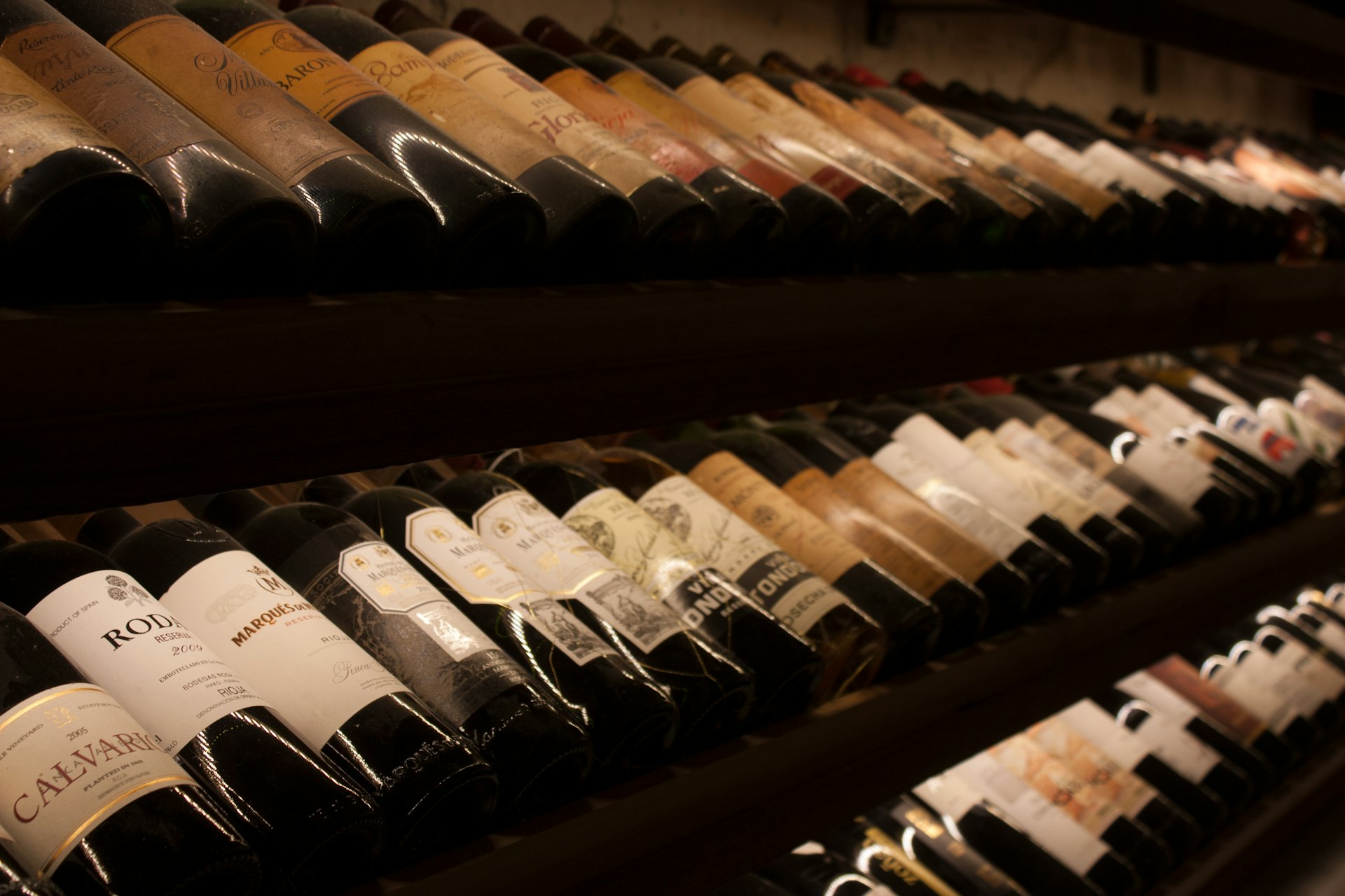cave black and white bottles on brown wooden shelf